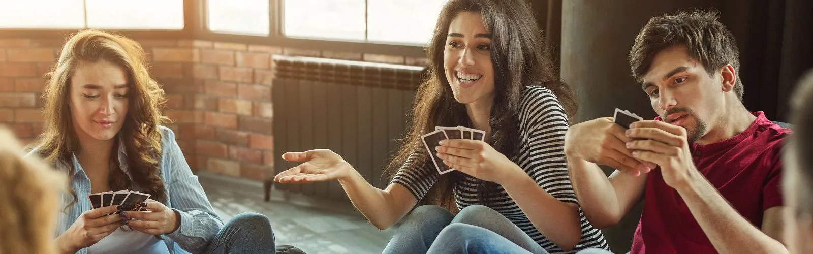 Happy group of friends playing cards