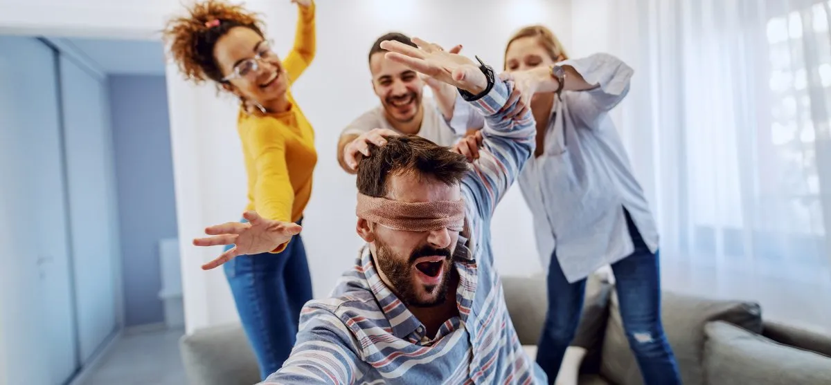 Group of cheerful friends having party at home They are playing Top Board Games